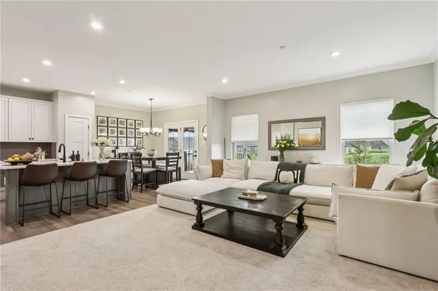 a living room with lots of furniture and a large window