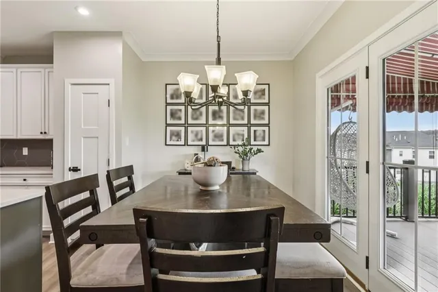 a view of a dining room with furniture and chandelier