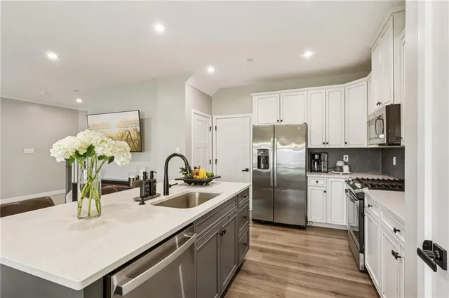 a kitchen with refrigerator a stove and cabinets