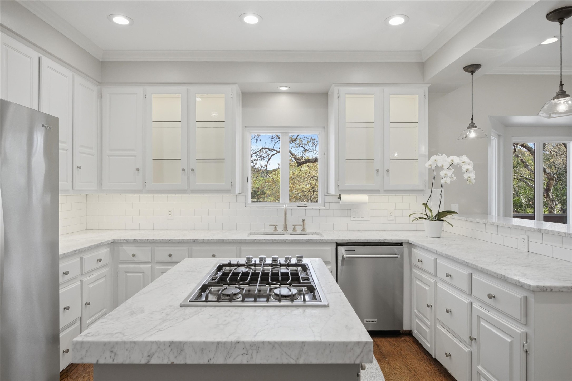 5705 Carry Back Lane Austin, TX 78746 - Photo 12 of 39 a kitchen with a sink stove and cabinets