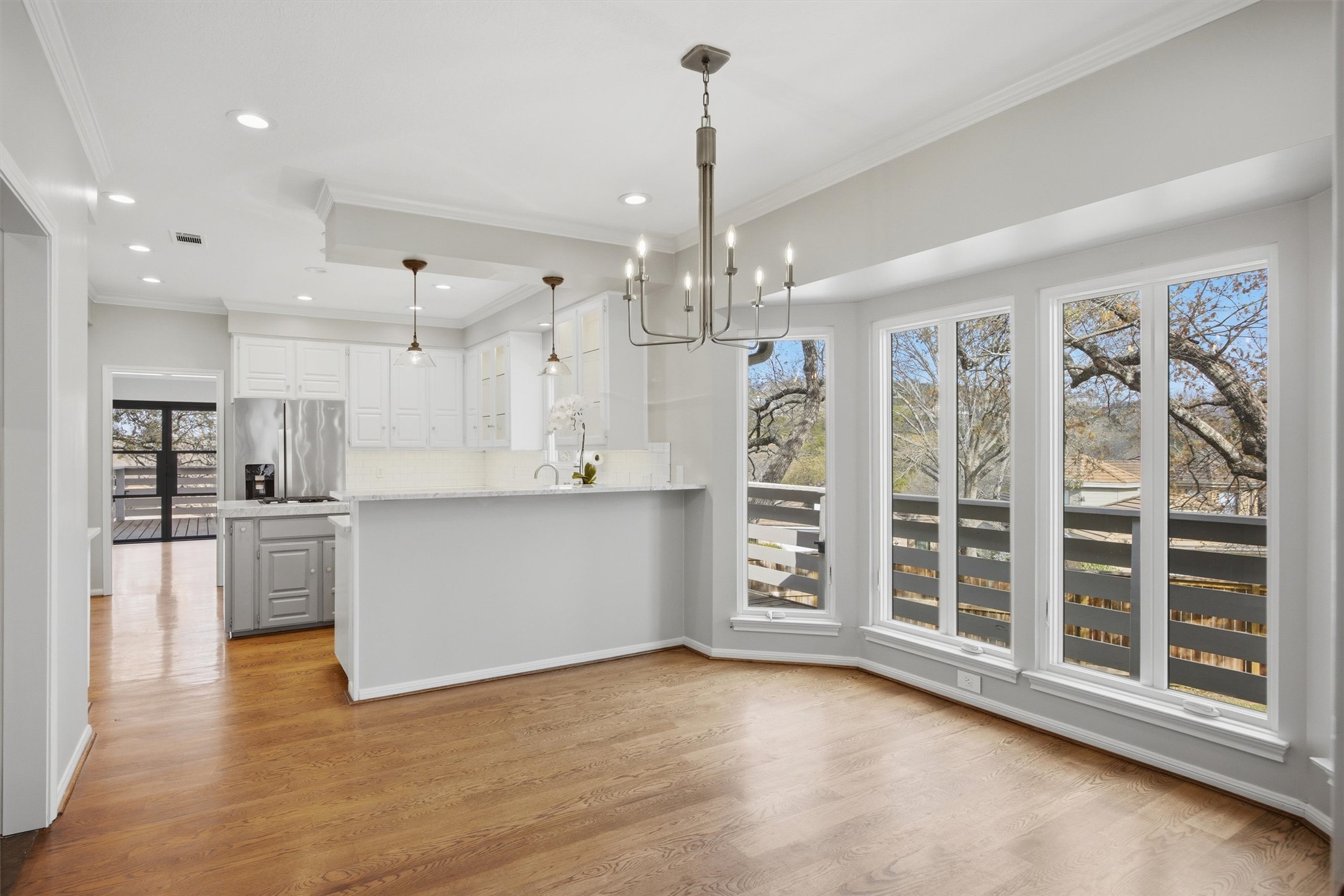 5705 Carry Back Lane Austin, TX 78746 - Photo 13 of 39 a view of an empty room with kitchen and window