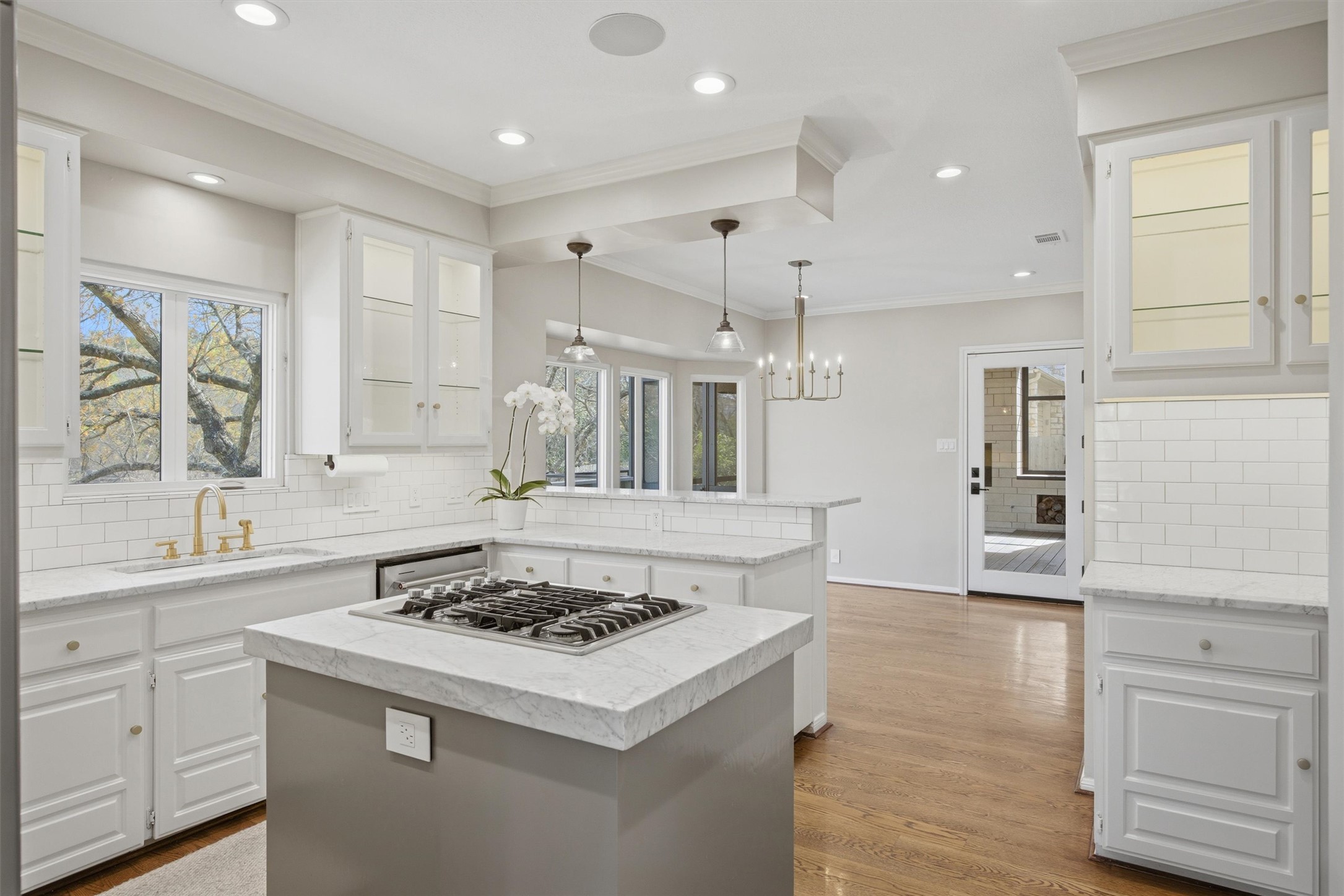 5705 Carry Back Lane Austin, TX 78746 - Photo 14 of 39 a kitchen with a stove a sink dishwasher and a refrigerator