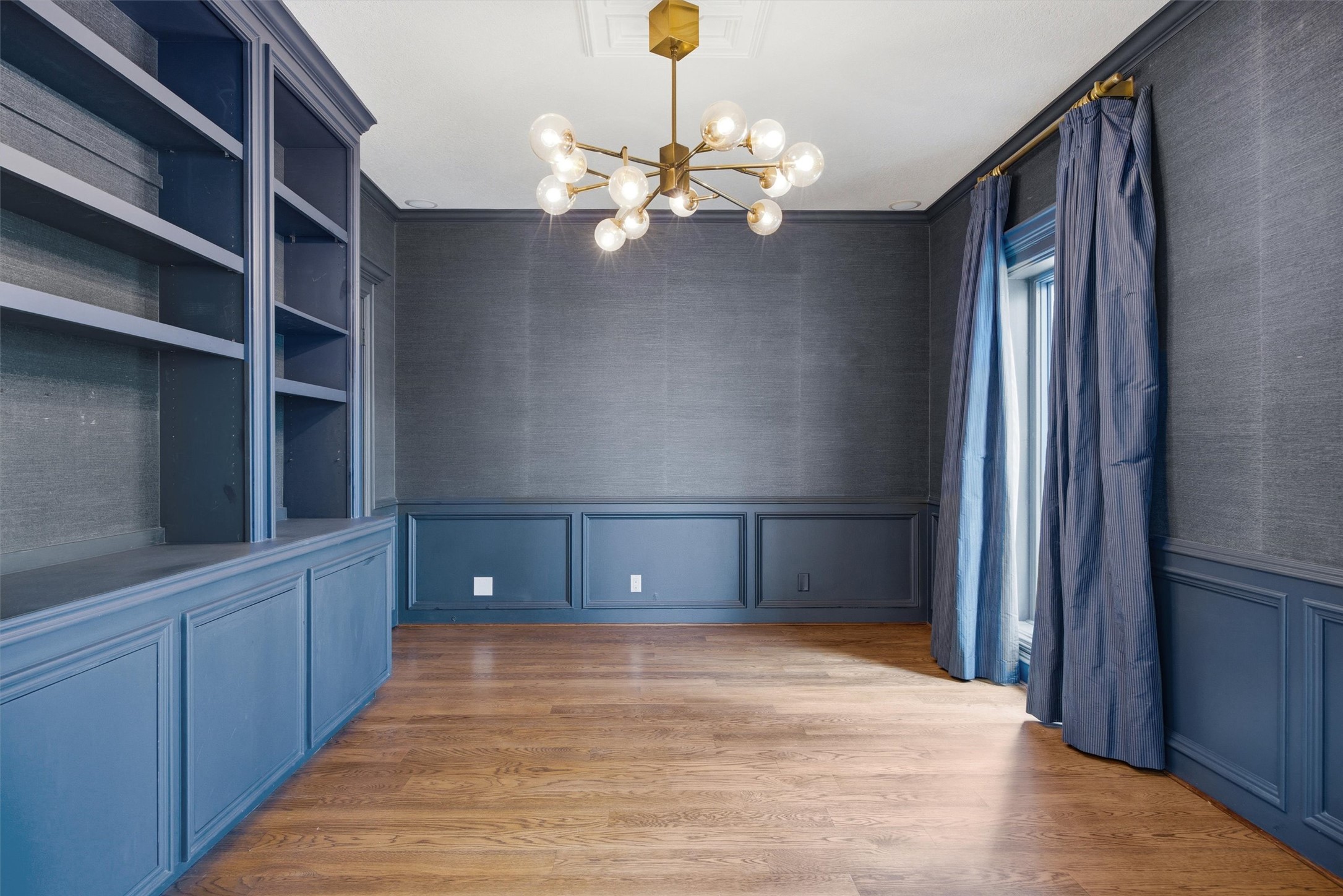 5705 Carry Back Lane Austin, TX 78746 - Photo 19 of 39 a view of an empty room with wooden floor and cabinet