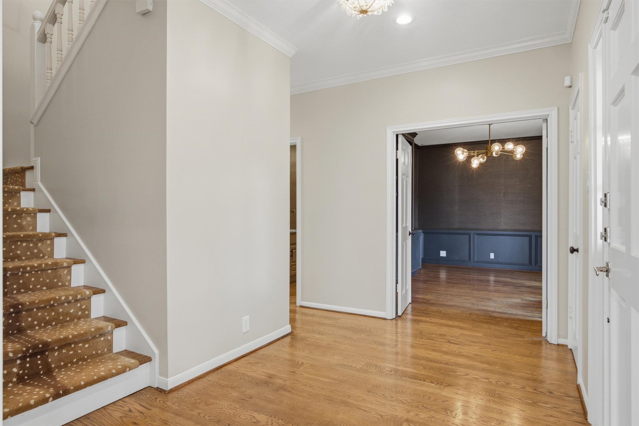 5705 Carry Back Lane Austin, TX 78746 - Photo 20 of 39 a view of a hallway with wooden floor and staircase