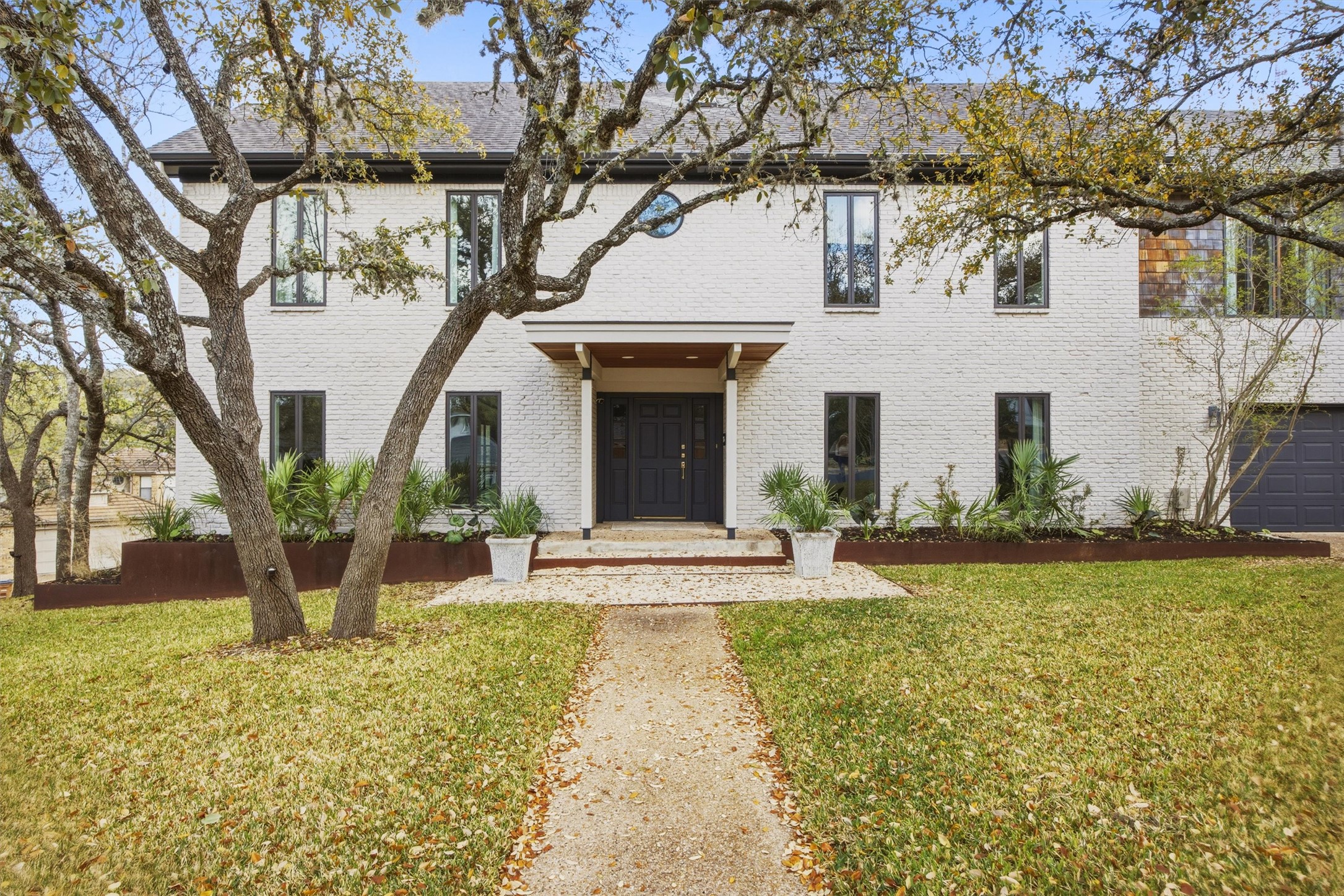 5705 Carry Back Lane Austin, TX 78746 - Photo 2 of 39 a view of a house with backyard and tree