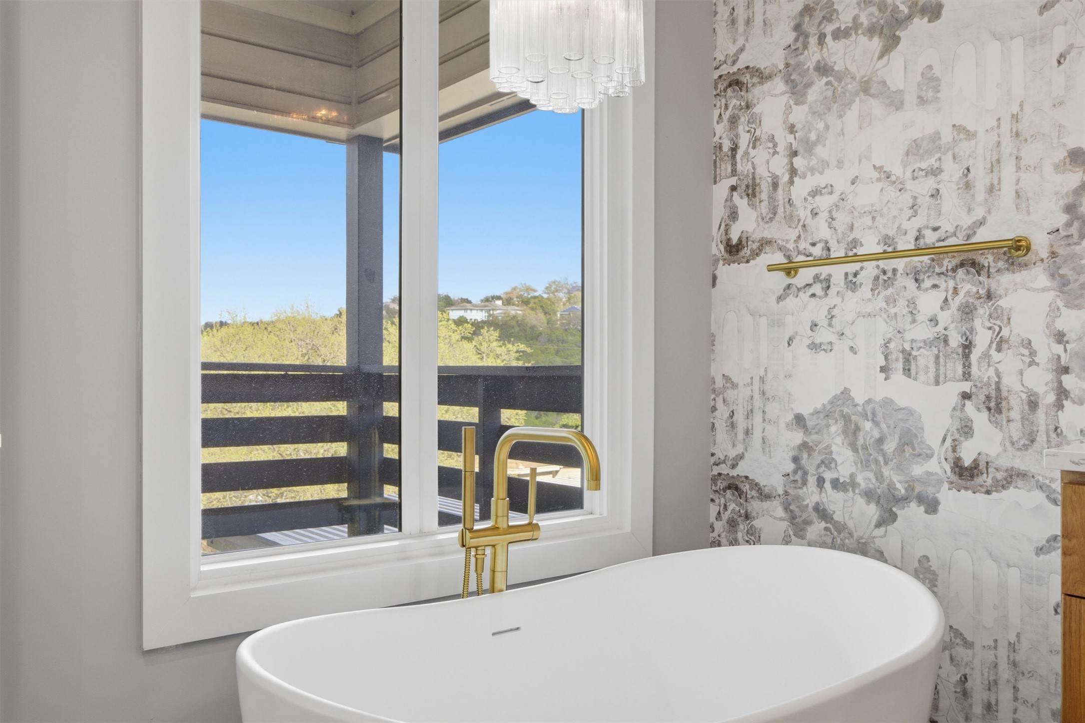 5705 Carry Back Lane Austin, TX 78746 - Photo 24 of 39 a bathroom with a bathtub and window