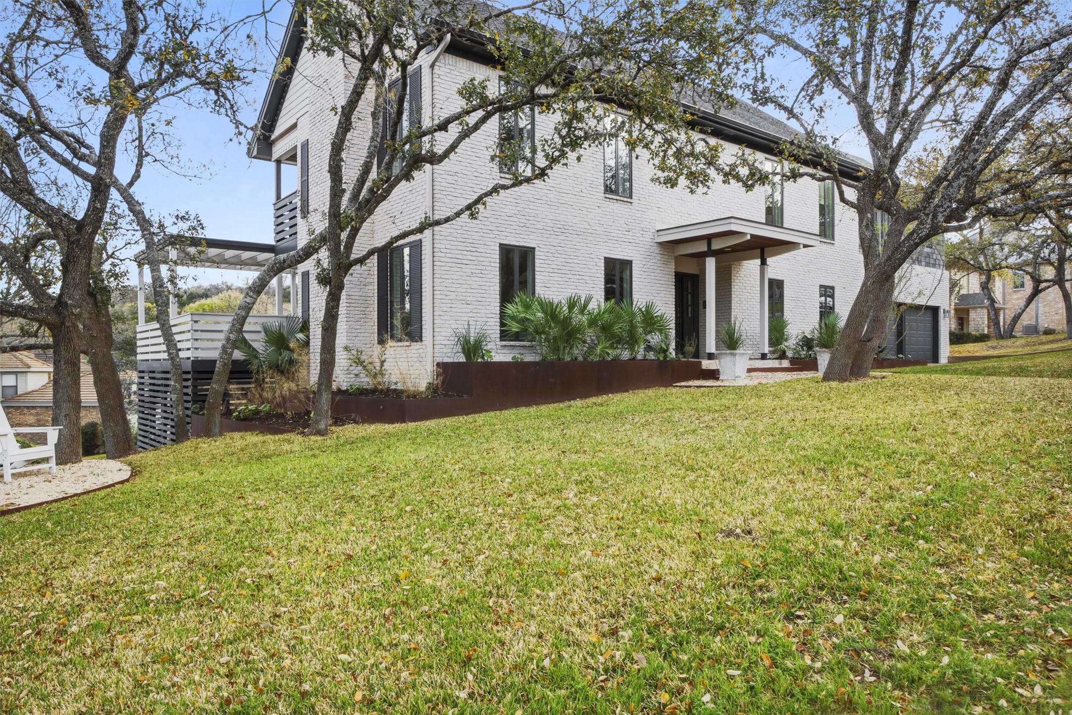 5705 Carry Back Lane Austin, TX 78746 - Photo 38 of 39 a front view of a house with a yard