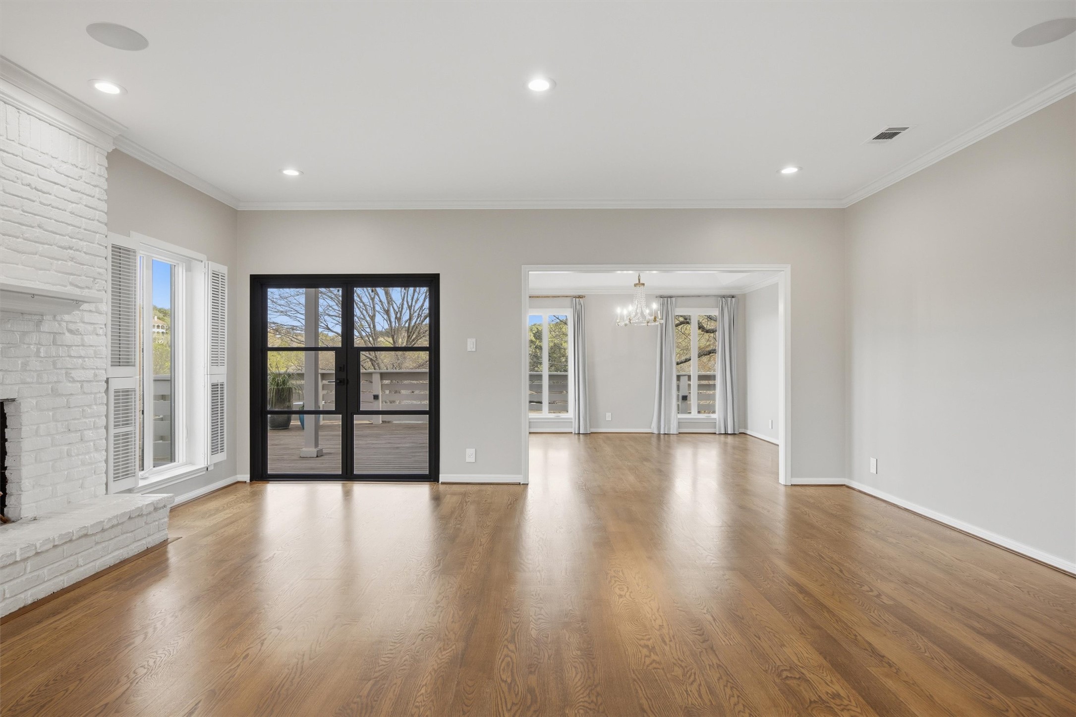 5705 Carry Back Lane Austin, TX 78746 - Photo 5 of 39 a view of an empty room with wooden floor and a window