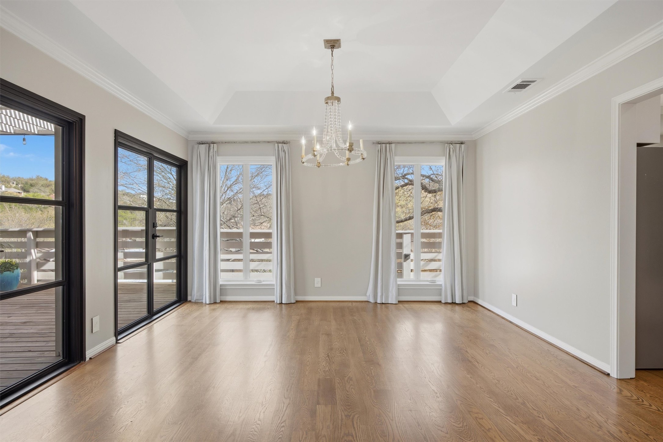 5705 Carry Back Lane Austin, TX 78746 - Photo 6 of 39 a view of an empty room with wooden floor and a window