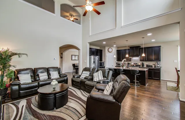 a living room with furniture and a kitchen view