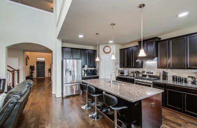 a kitchen with granite countertop lots of counter top space and stainless steel appliances