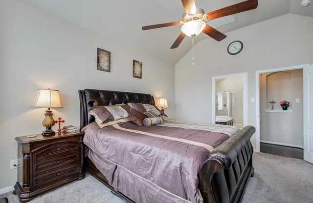 a bedroom with a bed and a chandelier