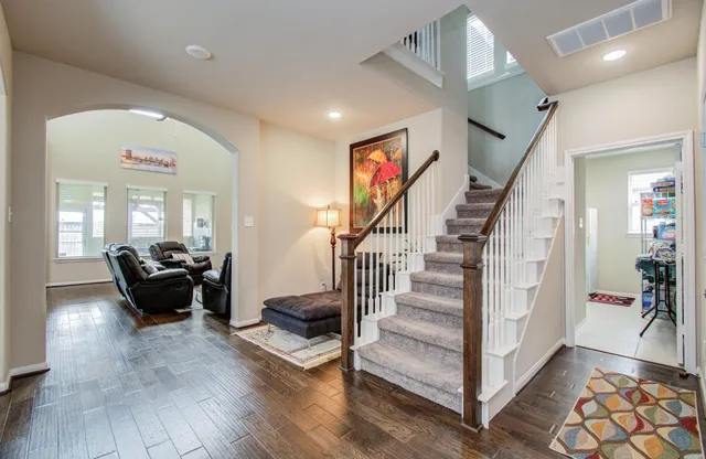 a living room with furniture and a wooden floor