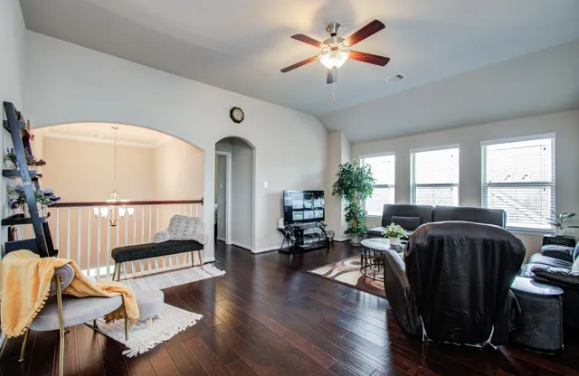 a living room with furniture fireplace and a large window
