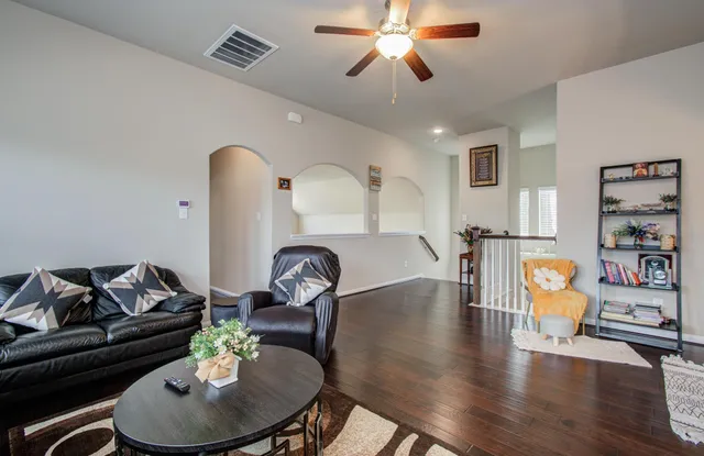 a living room with furniture and wooden floor