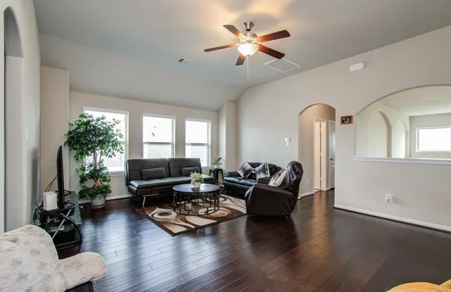 a living room with furniture or couch and a potted plant