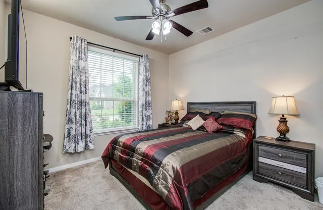 a bedroom with a bed and a chandelier
