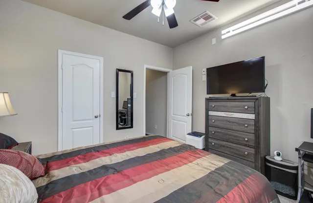 a bedroom with a bed and a flat screen tv