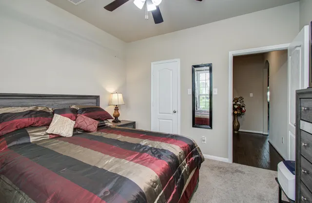 a bedroom with a bed and a lamp