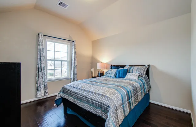 a bedroom with a bed and a window