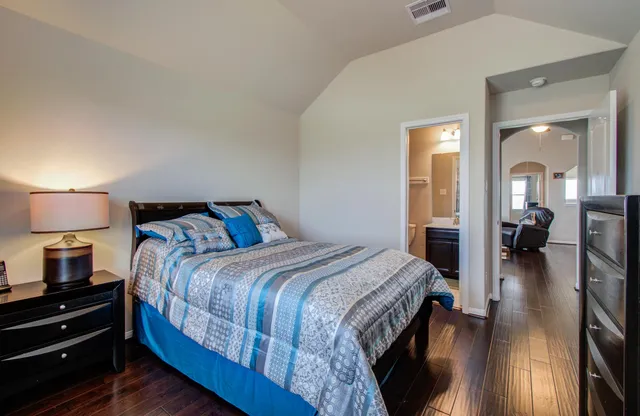 a bedroom with a bed and a lamp