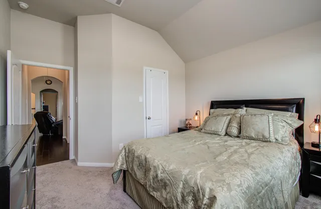 a bedroom with a bed and a mirror