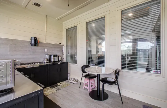 a kitchen with a table chairs and a window