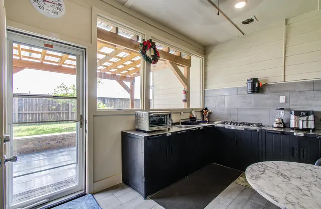 a kitchen with a sink a counter top space and a stove