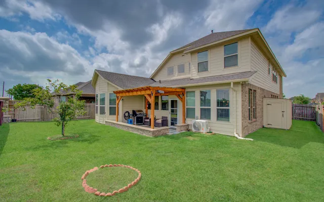 a view of a house with a yard and sitting area