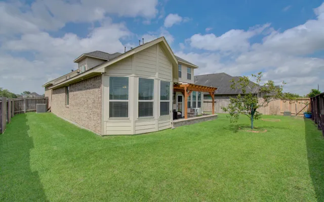 a view of a house with a yard and sitting area