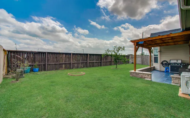 a view of a backyard with sitting area and furniture