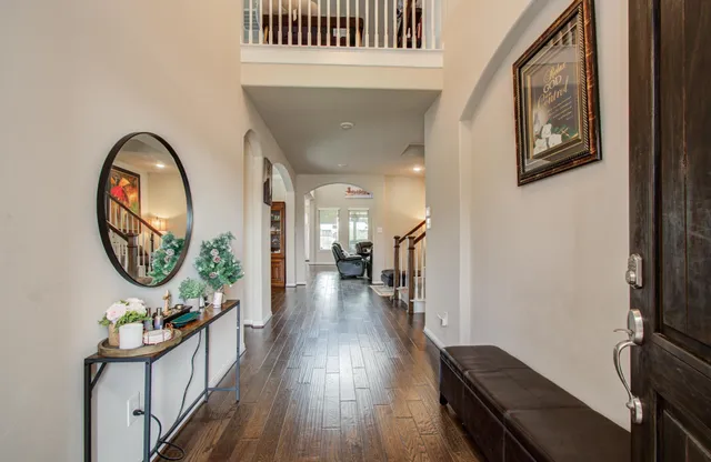a view of a hallway with wooden floor