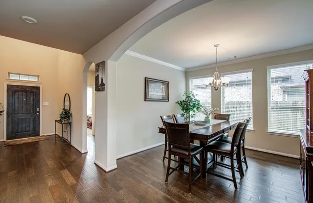 a view of a dining room with furniture and wooden floor