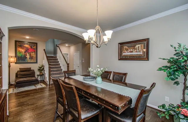 a dining room with furniture and wooden floor