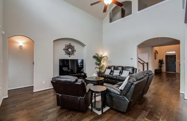 a living room with furniture and a mirror
