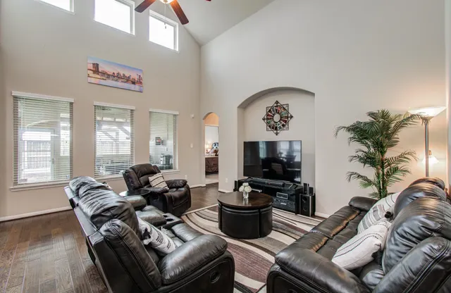 a living room with furniture couches and a flat screen tv