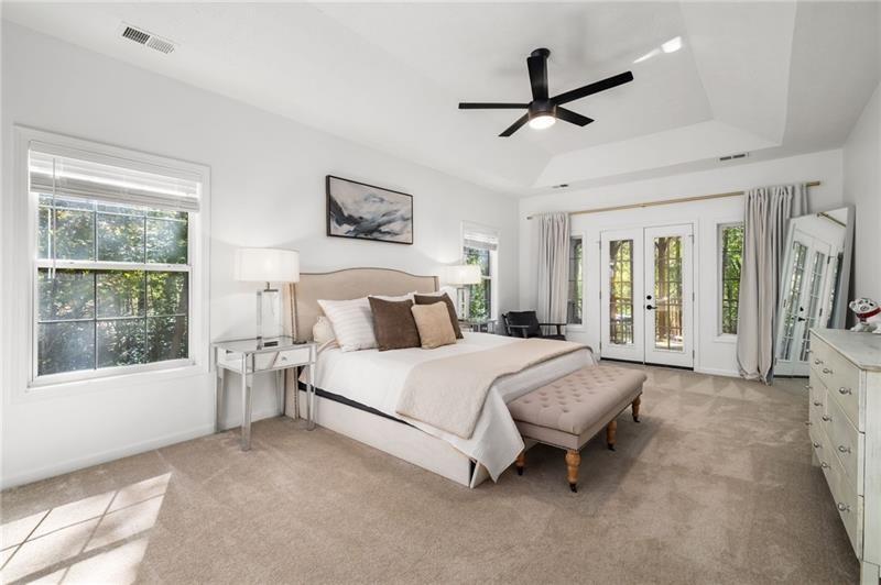 16218 Henderson Road Milton, GA 30004 - Photo 26 of 81 a spacious bedroom with a bed a chandelier and a window