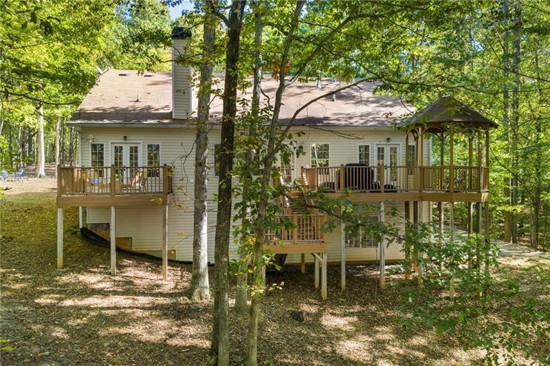 16218 Henderson Road Milton, GA 30004 - Photo 54 of 81 a yellow house with table and chairs in front of it