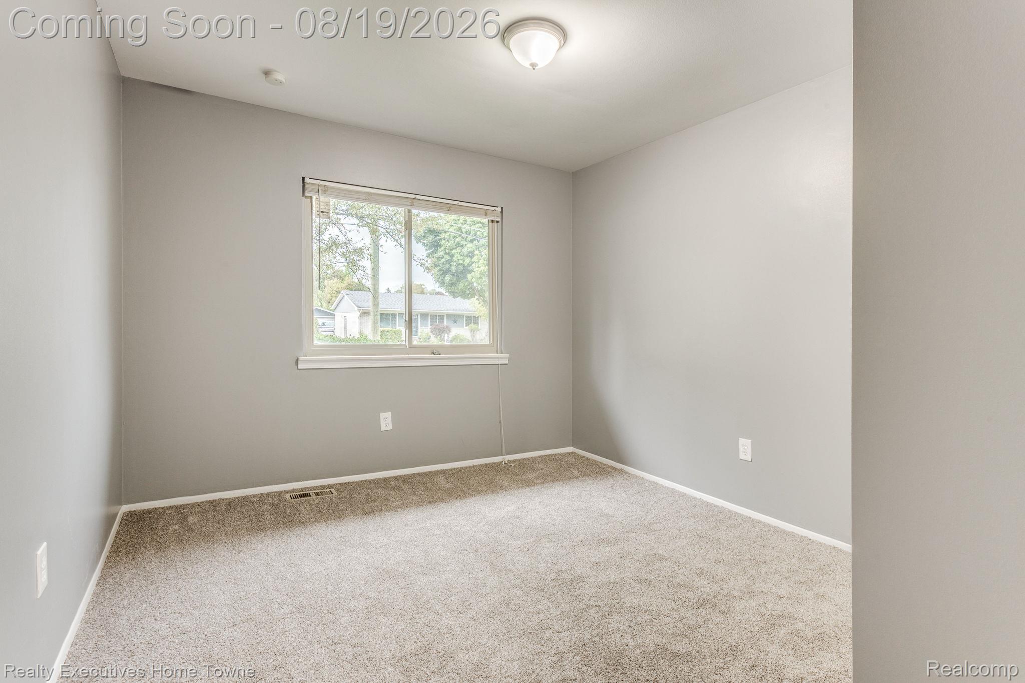 2448 Oakcrest Road Sterling Heights, MI 48310 - Photo 19 of 31 Neutral wall color, carpeted flooring, window with natural illumination, and ceiling-mounted light fixture