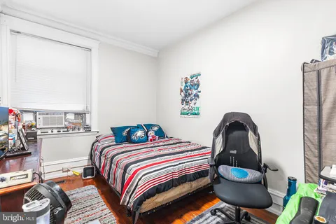 a bedroom with a bed and a potted plant