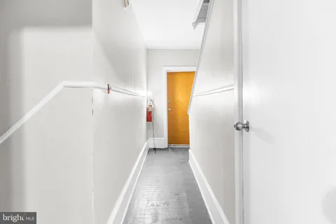 a view of a hallway with closet and a bathroom