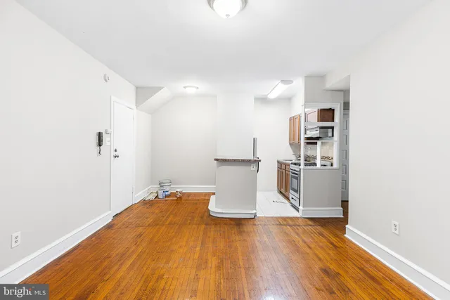 a view of empty room with wooden floor