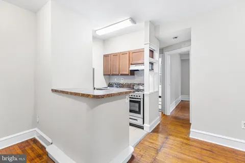 a kitchen with a refrigerator and a stove