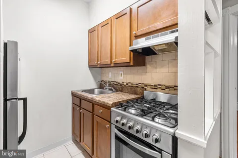 a kitchen with stainless steel appliances granite countertop a stove and a refrigerator
