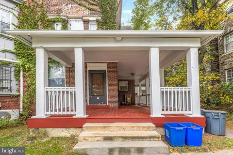 a view of front door of house with outdoor seating