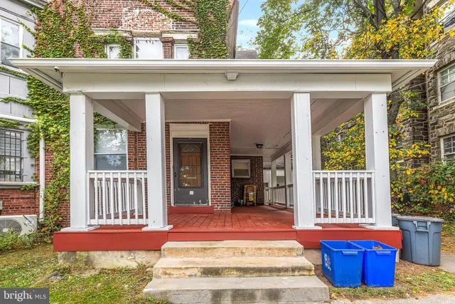 a view of front door of house with outdoor seating