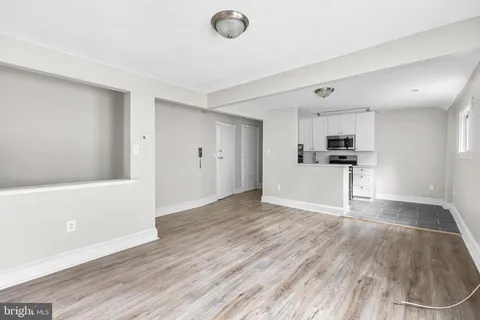 a view of a kitchen with wooden floor