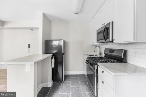 a kitchen with a stove microwave and a refrigerator