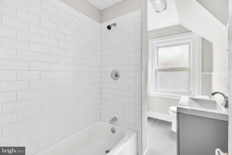 a bathroom with a bathtub and a sink