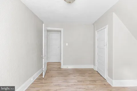 a view of an empty room and wooden floor